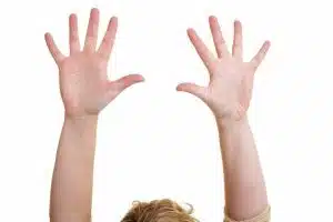 a person letting go with raised armes and open hands in the air